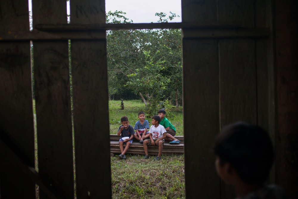 Boys from the Waorani of Pastaza indigenous group gather in their riverside village in the Amazon rainforest in the province of Pastaza, Ecuador, on April 25, 2022. Thomson Reuters Foundation/Fabio Cuttica