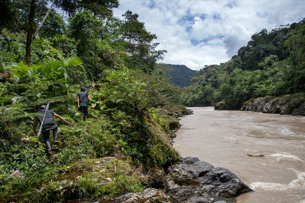 Members of the Cofan indigenous guard patrol the banks of the Aguarico River near their rainforest village of Sinangoe in northern Ecuador, on April 21, 2022. Patrols can take up to two weeks and are carried out regularly. Thomson Reuters Foundation/Fabio Cuttica